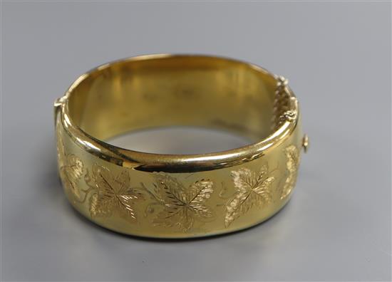 A modern silver gilt hinged bangle.